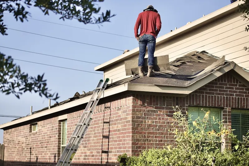 Professional roofer working on a residential roof in Brookside